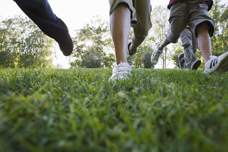 Young Boys Walking Across Grass Photograph by Sean Murphy
