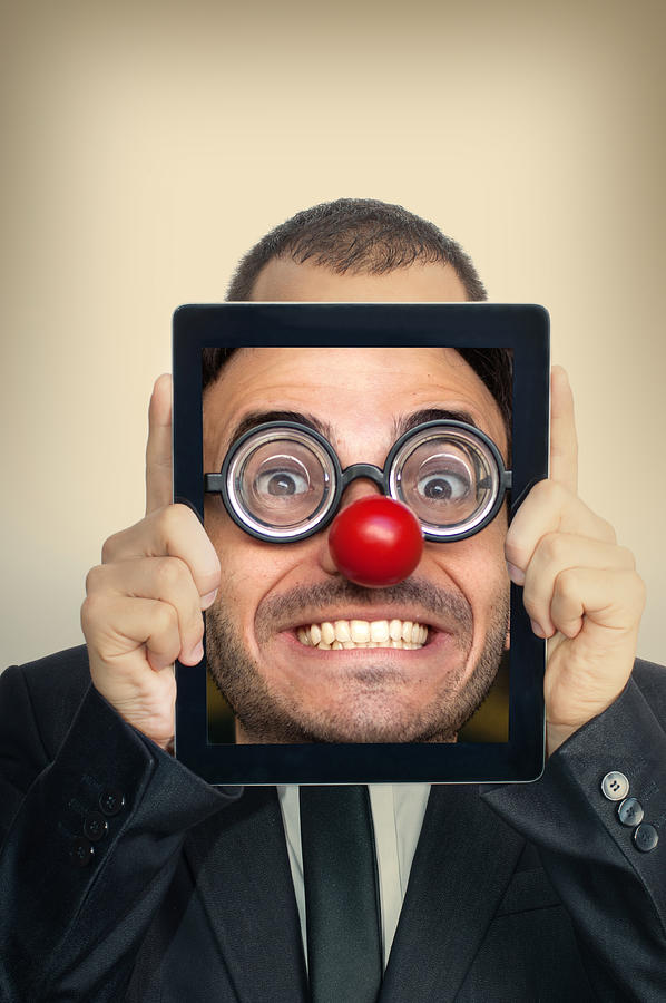 Young Businessman With Funny Face in a Digital Tablet Photograph by SeanShot
