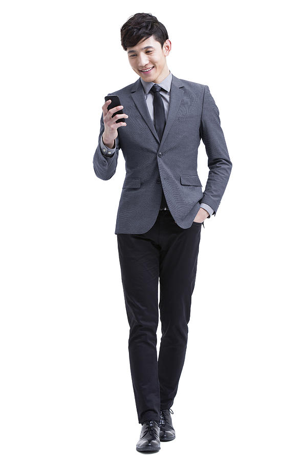 Young businessman with smart phone Photograph by Bji