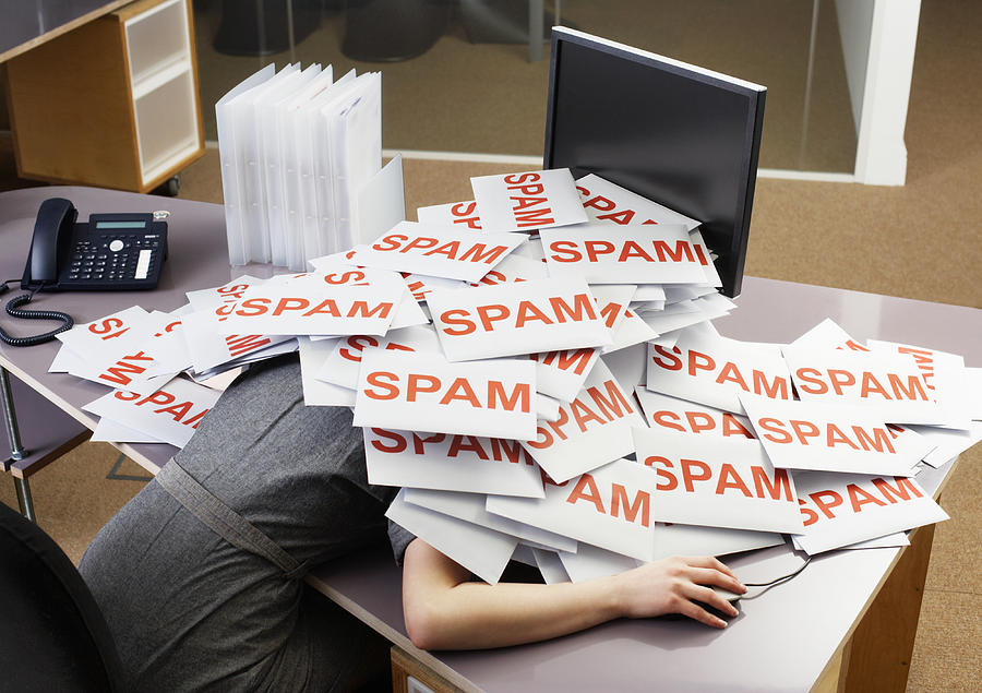 Young businesswoman at office desk with pile of spam envelopes Photograph by Tim Robberts