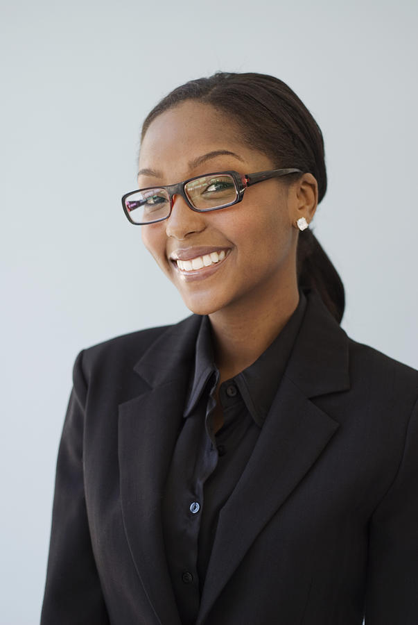 Young businesswoman smiling, portrait, close-up Photograph by Mark Hall