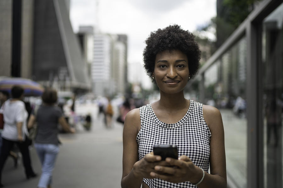 Young businesswoman using mobile portrait on the city Photograph by FG Trade