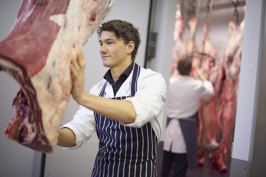 Young Butcher In The Meat Room Photograph by Sturti