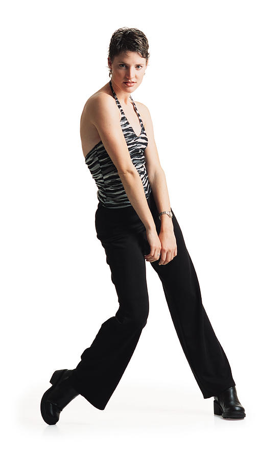 Young Caucasian Female Dancer In Black Pants Ans A Zebra Print Tank Top Dances As She Throws Her Shoulder Forward Photograph by Rubberball/Helen Thomas