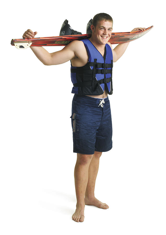 Young Caucasian Male Waterskier Wears Blue Lifejacket Swimsuit Holds Waterski Over Shoulders Smiles Photograph by Photodisc