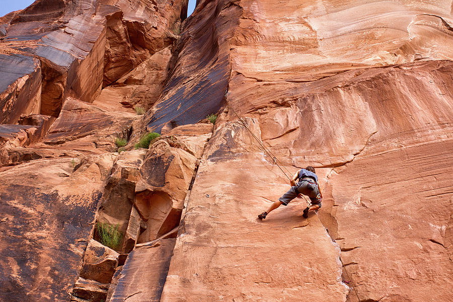 Young Caucasian Man Climbing a Rock Wall Near Moab Photograph by Grandriver