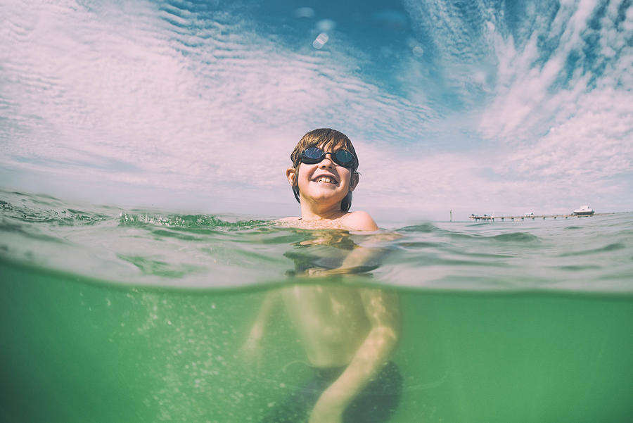 Young child swims in beautiful green waters of Florida Photograph by Vernonwiley