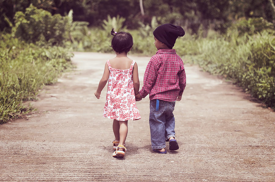Young children walking hand in hand Photograph by Gilbert Rondilla Photography