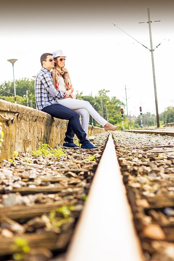 Young couple at the train station. Photograph by Jokic