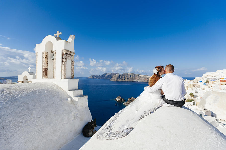 Young couple celebrating wedding at Santorini island, Cyclades, Greece Photograph by Alexander Spatari