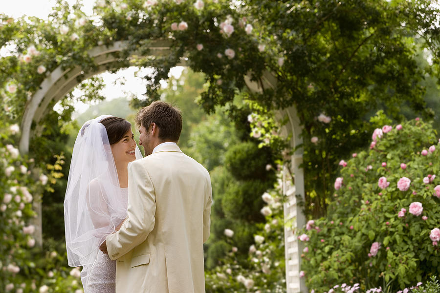 Young Couple Getting Married in Garden Photograph by Ariel Skelley