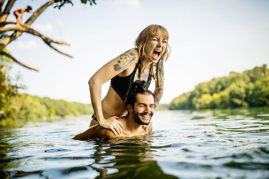 Young couple having fun at the lake Photograph by Luis Alvarez