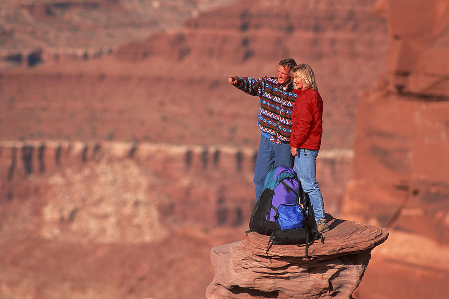 Young couple hiking at Dead-horse Point State Park , Moab , Utah Photograph by Comstock