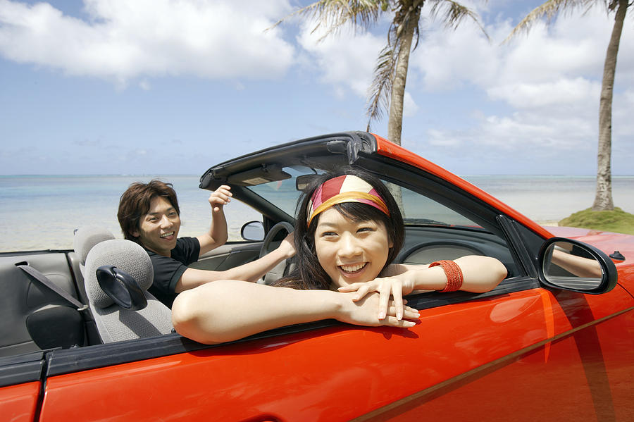 Young Couple in a Convertible by the Beach Photograph by Dex