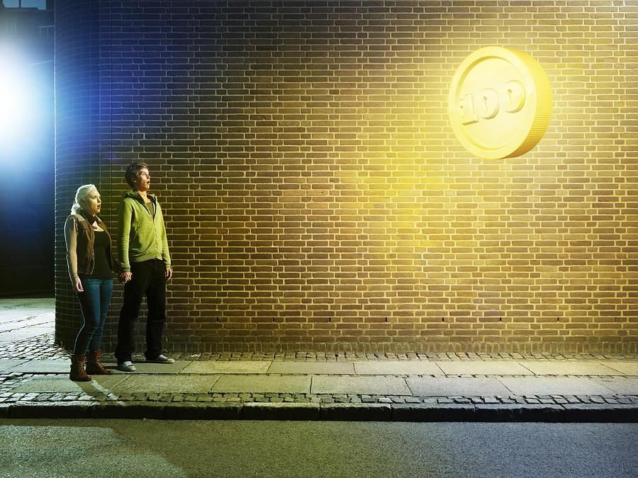 Young Couple In The Street, Looking Up At Coin Photograph by Henrik Sorensen