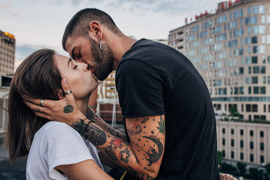 Young couple kissing Photograph by Hirurg