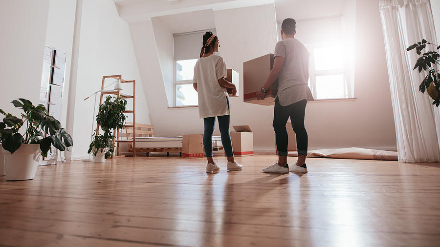 Young couple moving in new house Photograph by Jacoblund