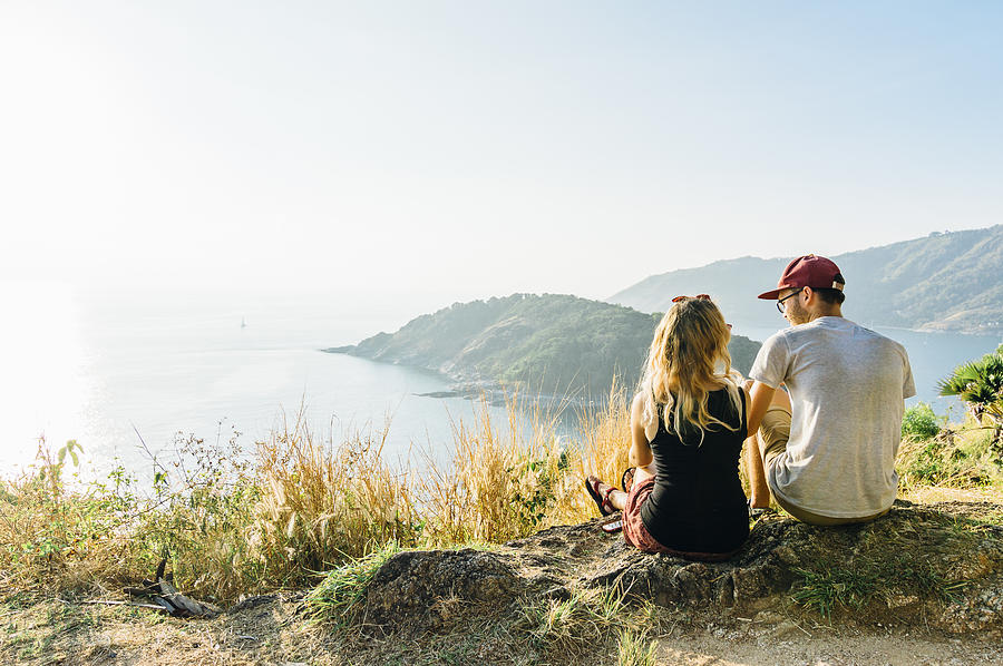 Young couple relax, on hillside above sea Photograph by Andrii Lutsyk/ Ascent Xmedia