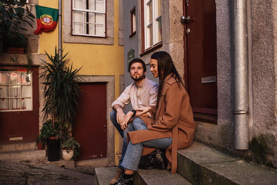 Young couple resting in a city street of Porto, Portugal Photograph by PatriciaEnciso