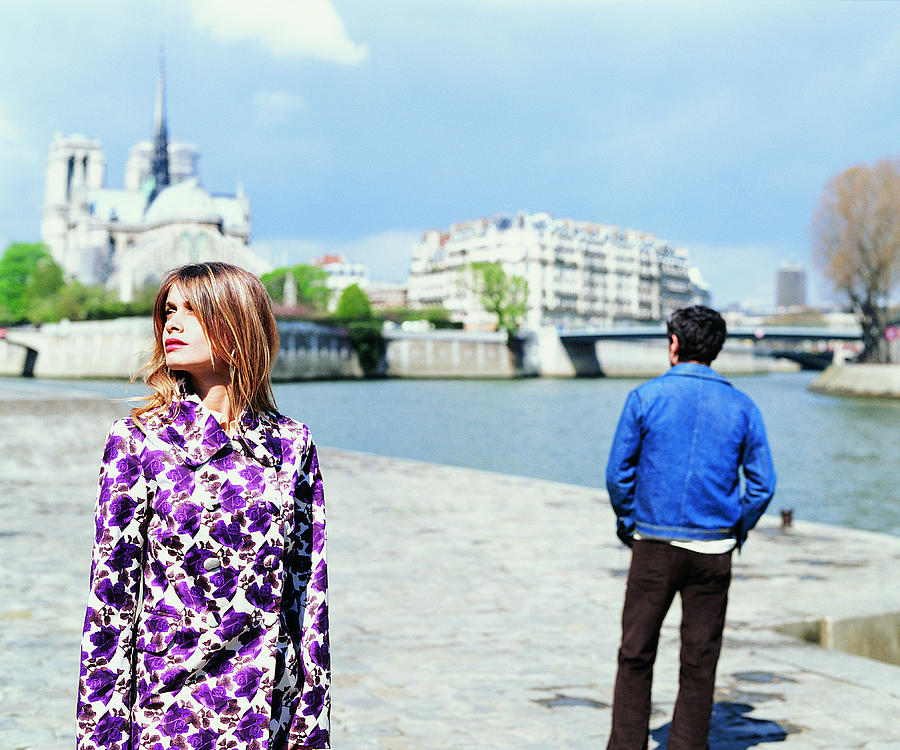 Young Couple Stand on the Left Bank of the River Seine with Notre Dame in the Background Photograph by Digital Vision.