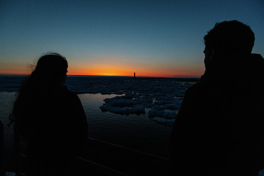 Young couple watching sunset over Lake Michigan in Holland Michigan Photograph by Eldon McGraw