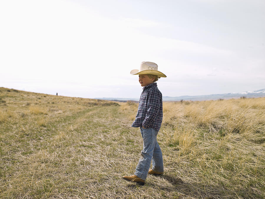 Young cowboy on the prairie Photograph by Ralf Nau
