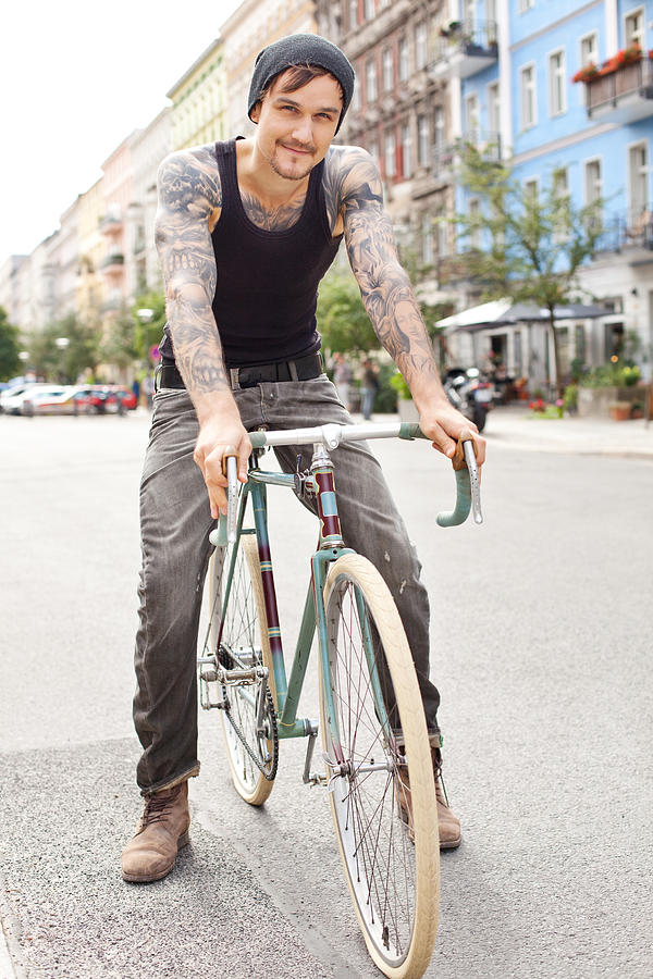 Young cyclist with tattoos in Berlin Photograph by Alvarez