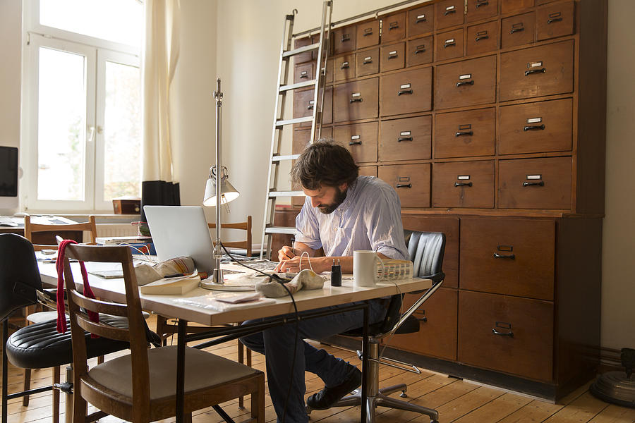 Young designer working in home office. Photograph by Simon Ritzmann
