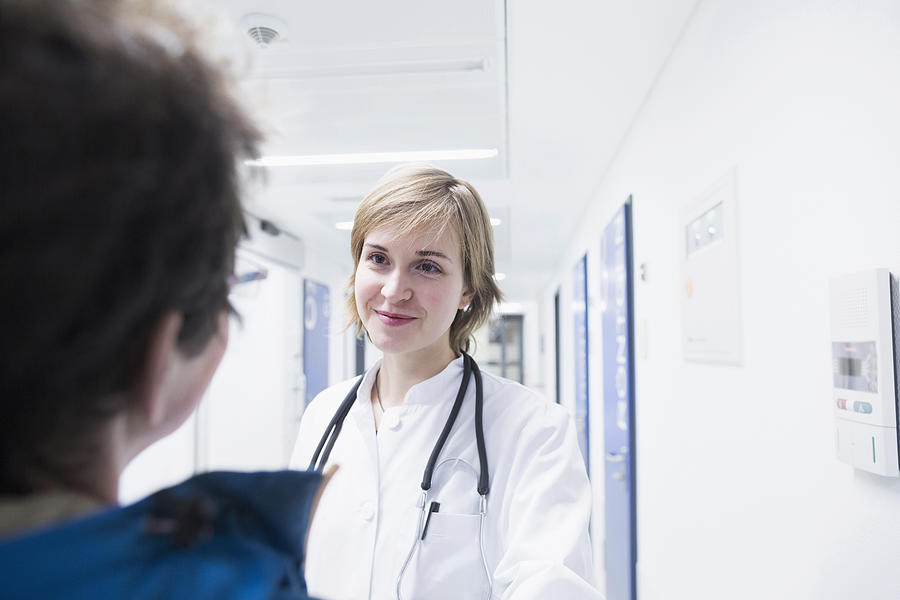 Young doctor talking with patient in a hospital, Freiburg Im Breisgau, Baden-Württemberg, Germany Photograph by Sigrid Gombert