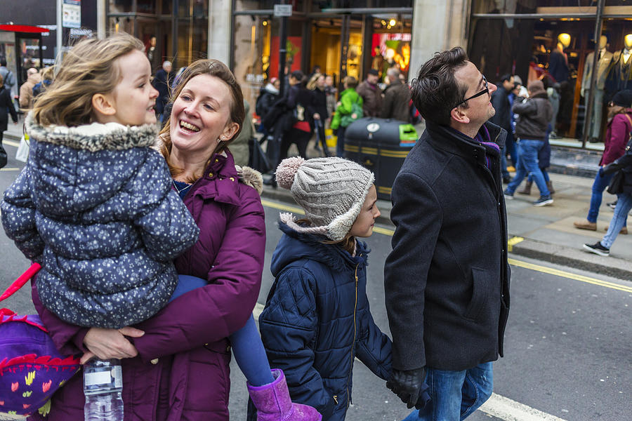 Young Family Sightseeing and Shopping at Christmas Markets Photograph by Davidf