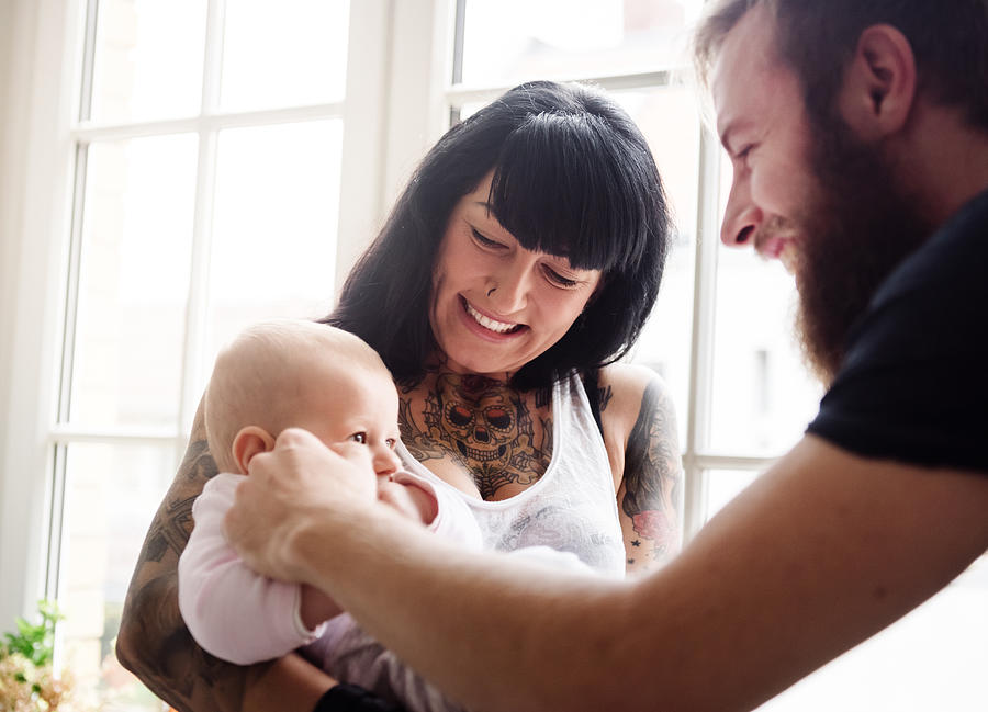 Young Family With Newborn Baby Beside Window Photograph by Hinterhaus Productions