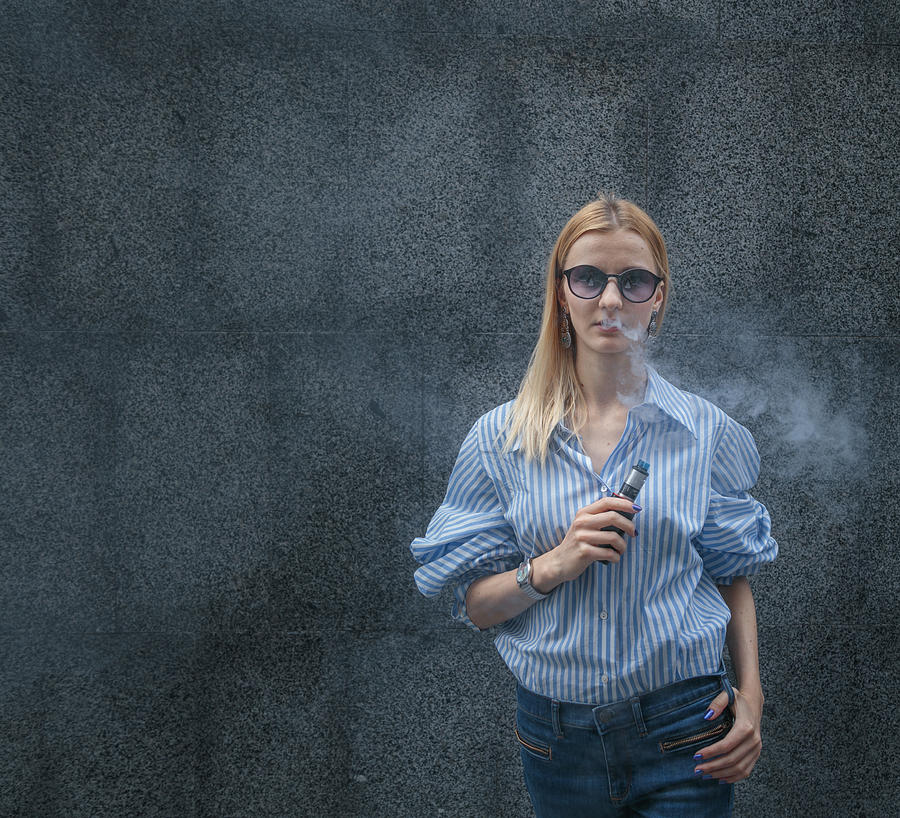 Young female smoking electronic cigarette Photograph by Artem Hvozdkov