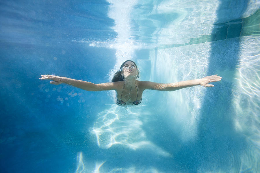 Young Girl Coming Up From Dive Under Pool Water Photograph by Justin Lewis
