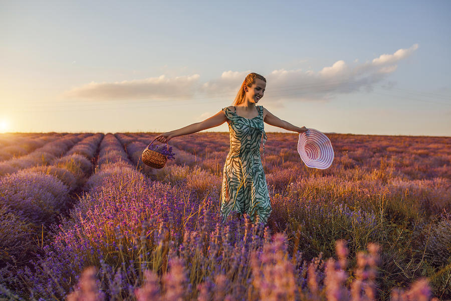 Young girl in a purple flowers of lavender Photograph by Viktor Cvetkovic