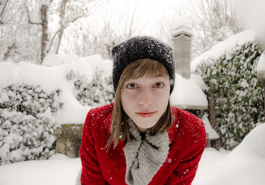 Young Girl in a red coat under the snow Photograph by Serena Cevenini