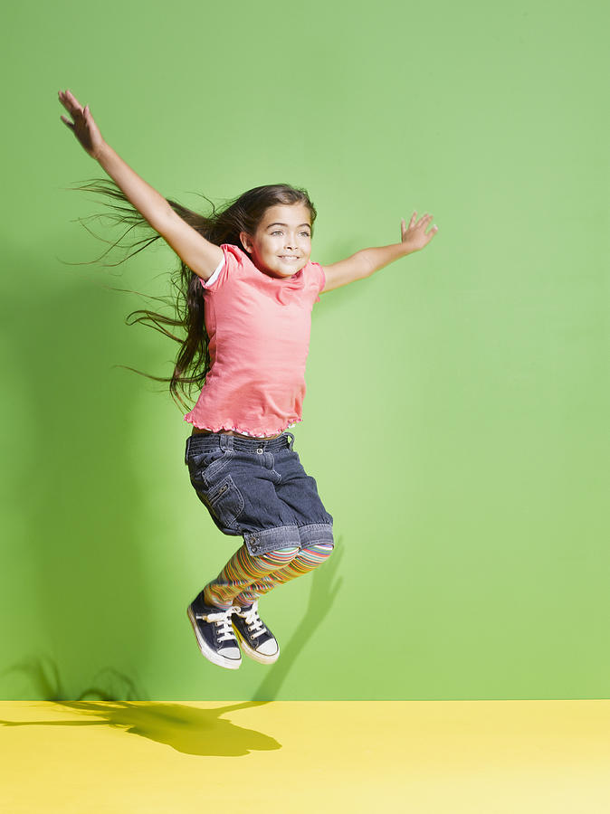 Young girl jumping in mid-air Photograph by Robert Daly