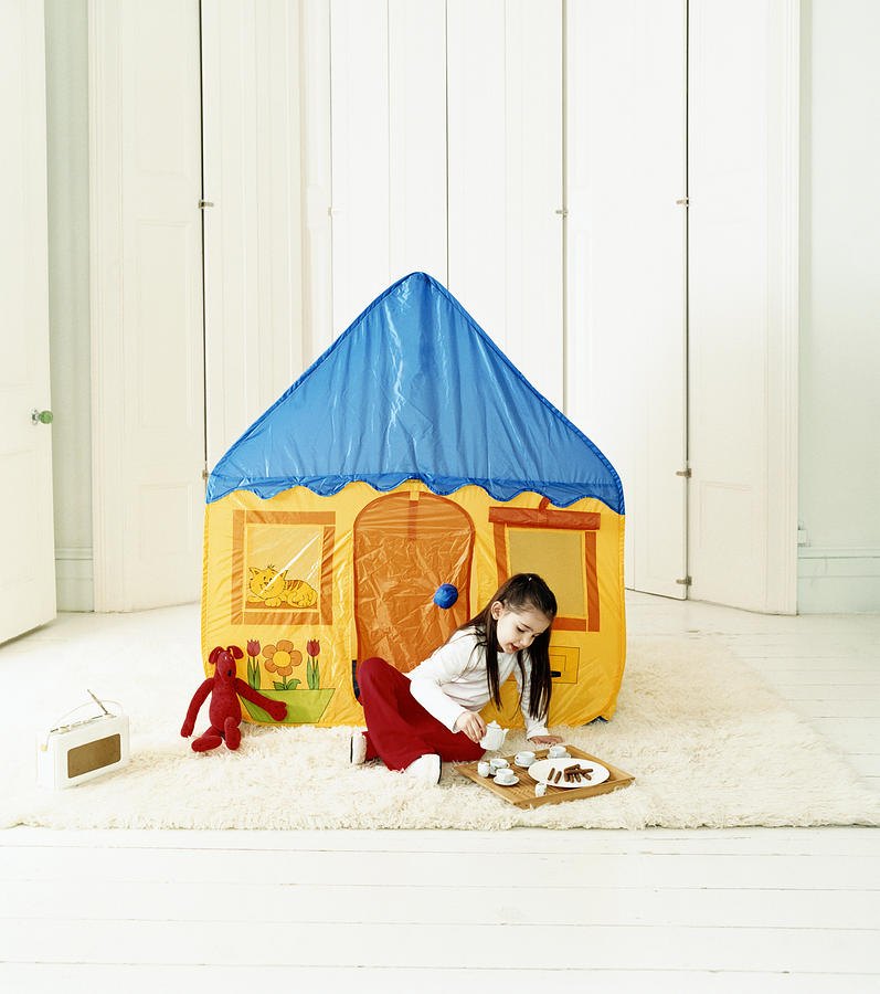 Young Girl Lying in a Playhouse Photograph by Lottie Davies