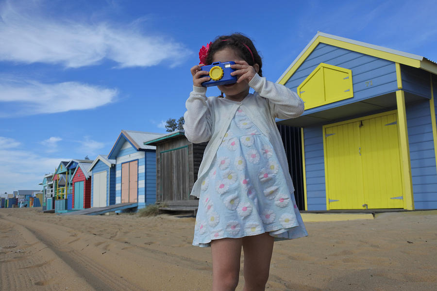 Young girl photographing the Iconic Bathing Boxes of the Mornington Peninsula Victoria Australia Photograph by Rafael Ben-Ari