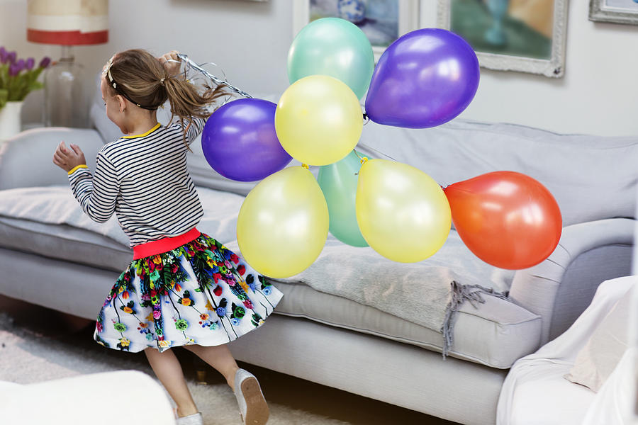 Young girl running with ballons Photograph by Michael Heffernan