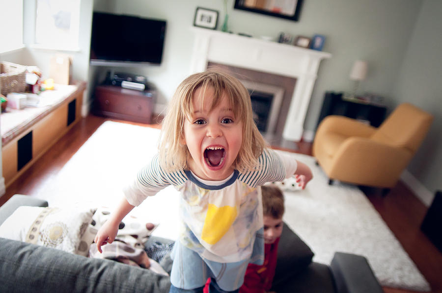 Young girl screaming and standing on couch Photograph by Teresa Short