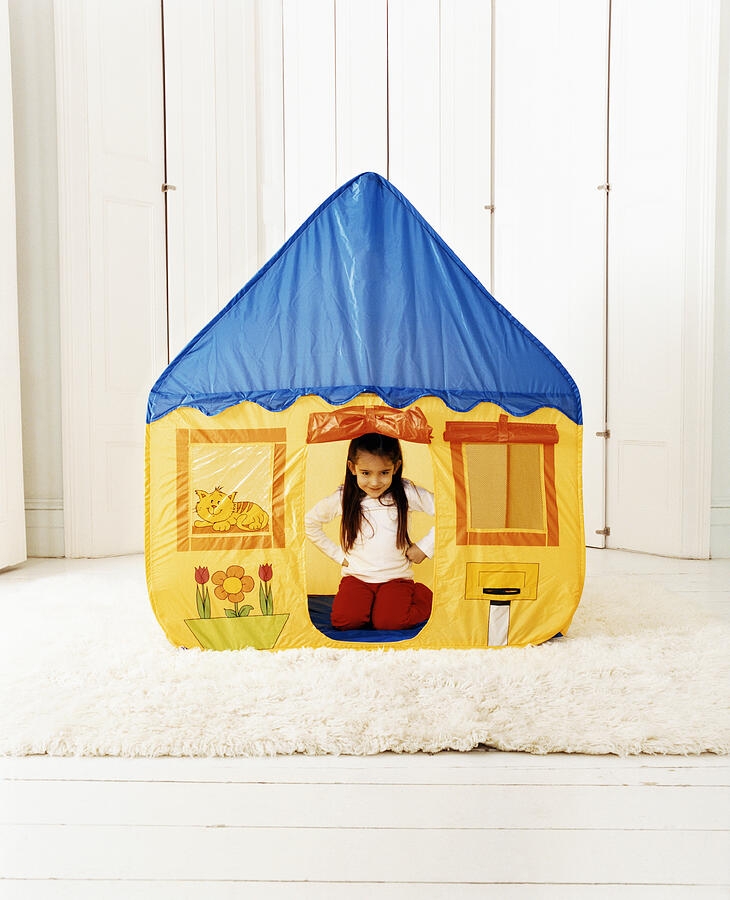 Young Girl Sitting Inside a House-Shaped Tent Photograph by Lottie Davies