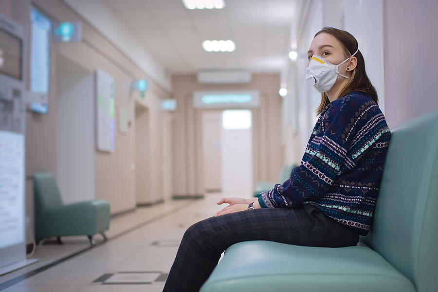 Young girl wearing protective mask in medical clinic Photograph by ArtMarie