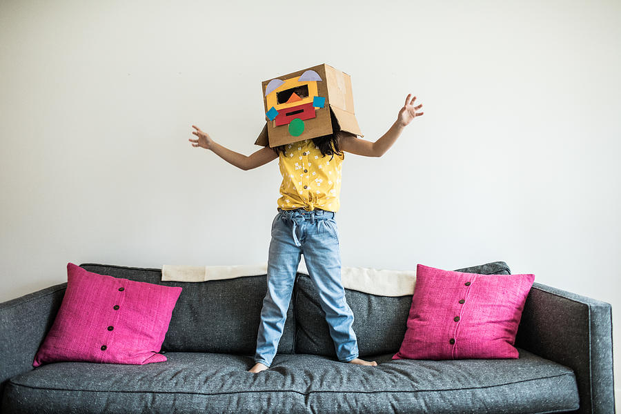Young girl wearing robot costume at home Photograph by MoMo Productions