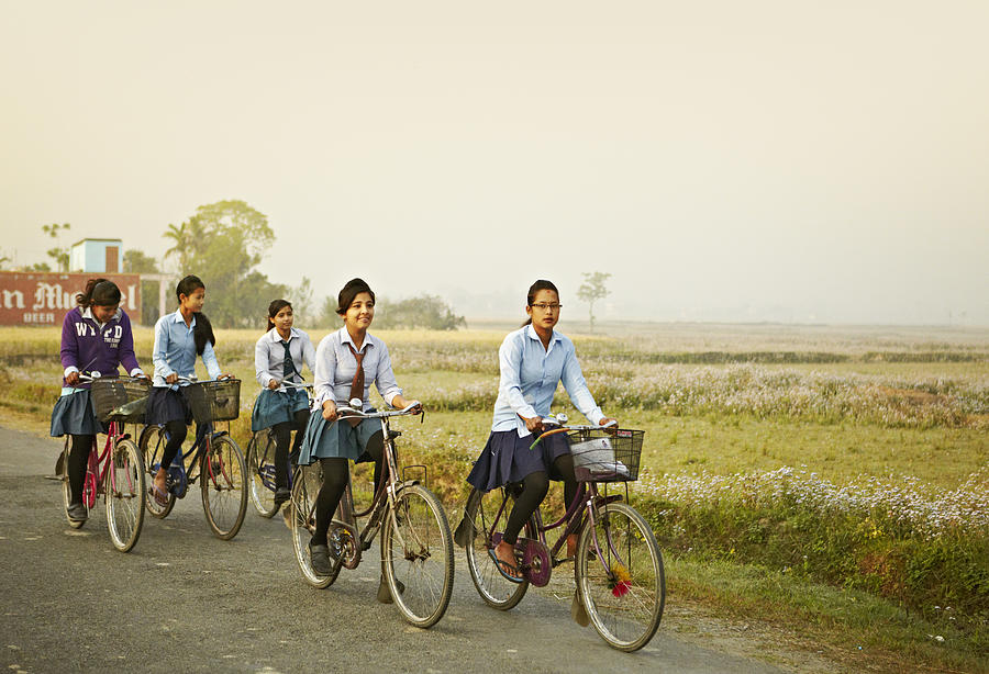Young Girls Going To School On Their Bicycle Photograph by Paper Boat Creative