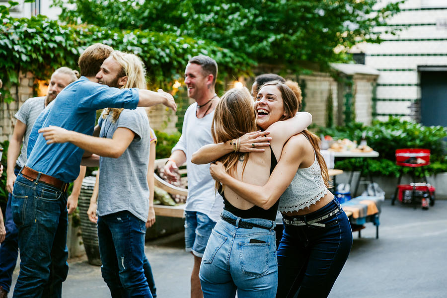 Young Group Of Friends Meeting Up For Barbecue, Hugging And Greeting Each Other. Photograph by Hinterhaus Productions