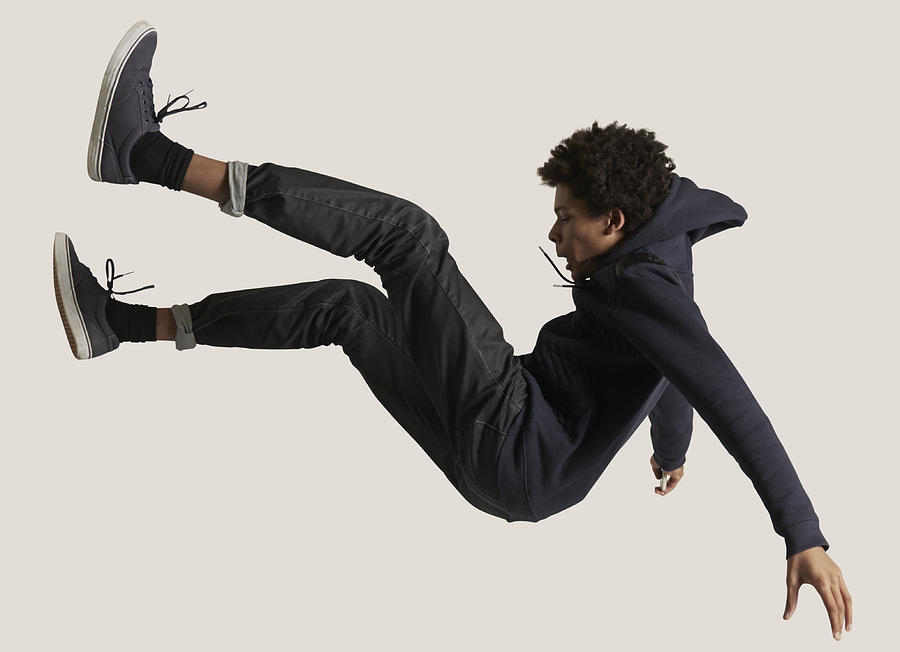 Young guy wearing hoodie, falling in the air Photograph by Klaus Vedfelt