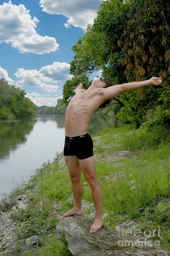 Young half naked man in nature feeling free Photograph by Gunther Allen