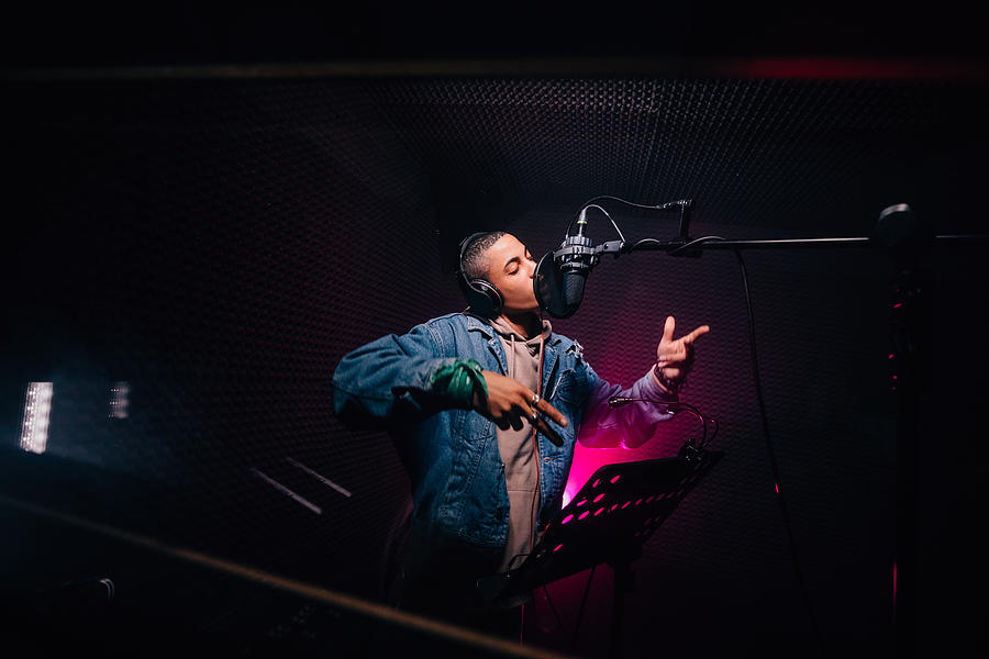 Young hipster African-American rapper recording songs in music recording studio Photograph by Wundervisuals