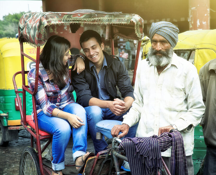 Young indian couple in rickshaw w their driver. Photograph by T-lorien