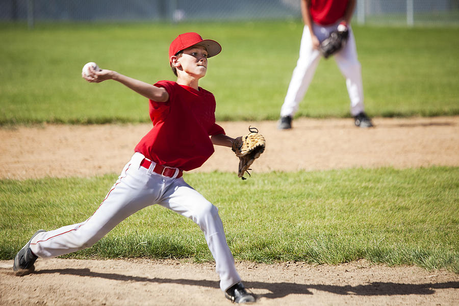 Young Male Baseball Pitcher Powers through Delivery Photograph by Strickke